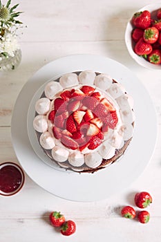 Delicious and sweet cake with strawberries and baiser on a plate photo