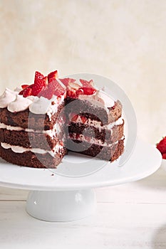 Delicious and sweet cake with strawberries and baiser on a plate photo