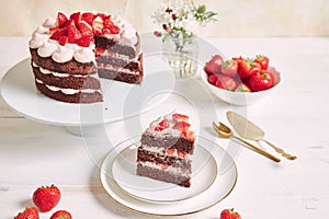 Delicious and sweet cake with strawberries and baiser on a plate photo