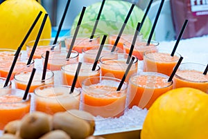 Delicious sweet cocktails and fresh fruits in the shop with takeaway