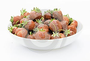 delicious, so sweet and juicy strawberries on a white plate