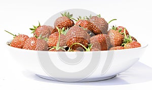 delicious, so sweet and juicy strawberries on a white plate