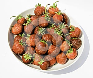 delicious, so sweet and juicy strawberries on a white plate