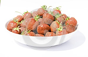 delicious, so sweet and juicy strawberries on a white plate