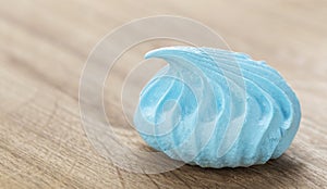 Delicious and sweet meringue in blue color close-up