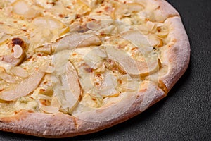 Delicious sweet pizza with pear, dorblu cheese and nuts