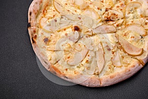 Delicious sweet pizza with pear, dorblu cheese and nuts