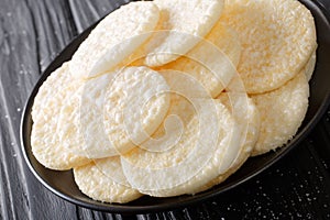 Delicious sweet rice cakes with sugar close-up on a plate. horizontal