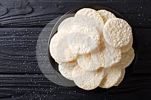 Delicious sweet rice cakes with sugar close-up on a plate. Horizontal top view