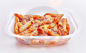 Delicious take away plate of italian macaroni with tomato sauce over isolated white background