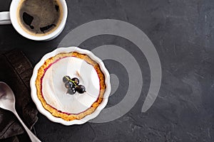 Delicious tart decorated with burned merengue and berries, served in white rustic composition, with copy space. Top view