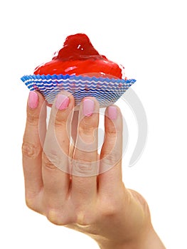 Delicious tasty sweet cake cupcake in human hand.