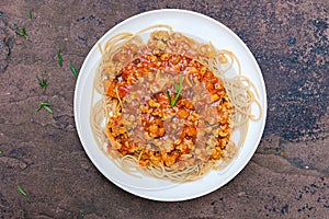 Delicious tasty yummy spaghetti with minced pork tomato sauce and green rosemary in white plate