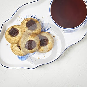 Delicious tea and biscuits with quince jam