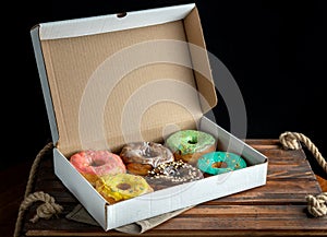 Delicious and tempting box full of colour donuts.