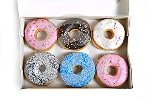 Delicious and tempting box full of donuts with different flavours and toppings sugar addiction concept