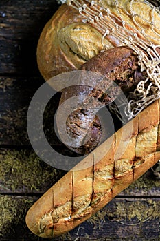Delicious textured black bread, white loaf, baguette. Against the background of a rustic in the 1990s grid.