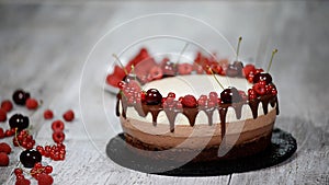 Delicious three layered chocolate mousse cake, decorated with fresh berries.