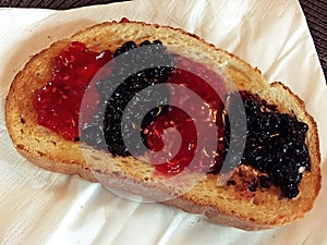 A delicious toast with butter and berry jams.