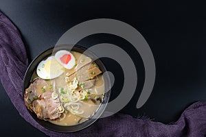 Delicious tonkotsu ramen, Japanese noodle in pork Bone based soup topped with chashu pork, boiled egg, pickled bamboo shoot photo