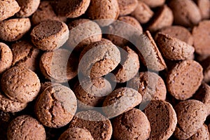 A delicious topdown portrait of a pile of tasty traditional dutch snacks called pepernoten or pepernuts. The gingerbread treat is