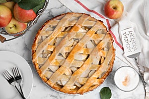 Delicious traditional apple pie on white marble table, flat lay