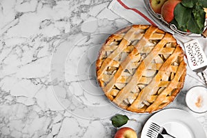 Delicious traditional apple pie on white marble table, flat lay. Space for text