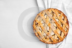 Delicious traditional apple pie on white table, top view. Space for text