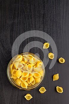 Delicious traditional conchiglie paste shells Italian macaroni pasta in the glass jar