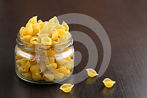 Delicious traditional conchiglie paste shells Italian macaroni pasta in the glass jar