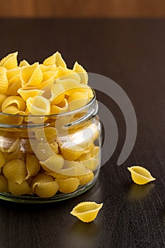 Delicious traditional conchiglie paste shells Italian macaroni pasta in the glass jar