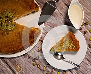 Delicious Traditional Dessert Knafeh with cheese and pistachios and orange flower syrup