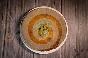 Delicious Traditional Dessert Knafeh with cheese and pistachios and orange flower syrup