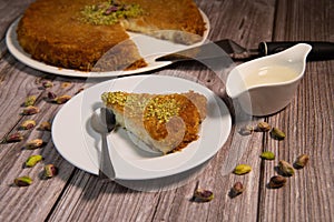 Delicious Traditional Dessert Knafeh with cheese and pistachios and orange flower syrup