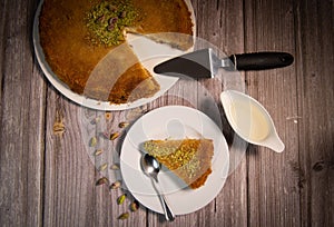 Delicious Traditional Dessert Knafeh with cheese and pistachios and orange flower syrup