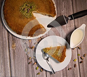 Delicious Traditional Dessert Knafeh with cheese and pistachios and orange flower syrup