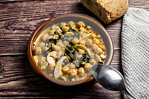 Delicious and traditional dish of chickpea stew with spinach and egg