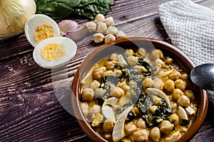 Delicious and traditional dish of chickpea stew with spinach and egg