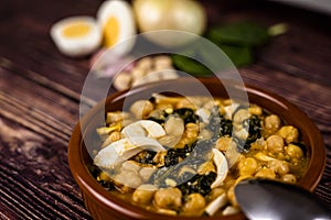 Delicious and traditional dish of chickpea stew with spinach and egg