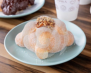 Delicious traditional mexican pan de muerto, with cajeta on top, sugar, inside a coffee, for the day of the dead, mexican culture