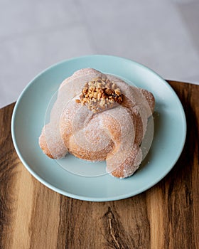 Delicious traditional mexican pan de muerto, with cajeta on top, sugar, inside a coffee, for the day of the dead, mexican culture