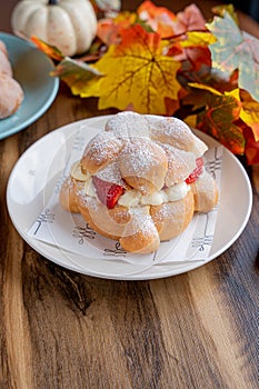 Delicious traditional mexican pan de muerto, filled with delicious cream, with red fruits inside, strawberries and blackberries