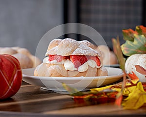 Delicious traditional mexican pan de muerto, filled with delicious cream, with red fruits inside, strawberries and blackberries