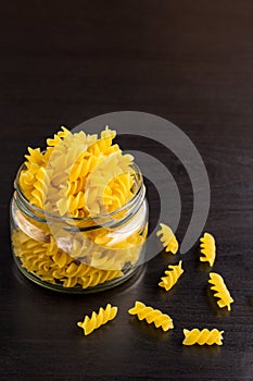 Delicious traditional pasta spiral fusilli macaroni in the glass jar