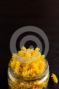 Delicious traditional pasta spiral fusilli macaroni in the glass jar