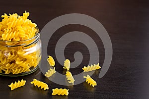 Delicious traditional pasta spiral fusilli macaroni in the glass jar
