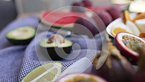 Delicious tropical fruits lying on summer day on terrace with live camera moving along tasty food. Healthful vitamin