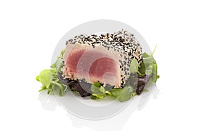 Delicious tuna steak on green salad