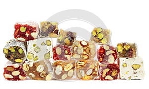 Delicious Turkish delight with nuts on white background.