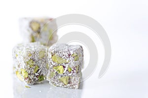 Delicious Turkish delight with pistachio and coconut on a white background, isolated, close up